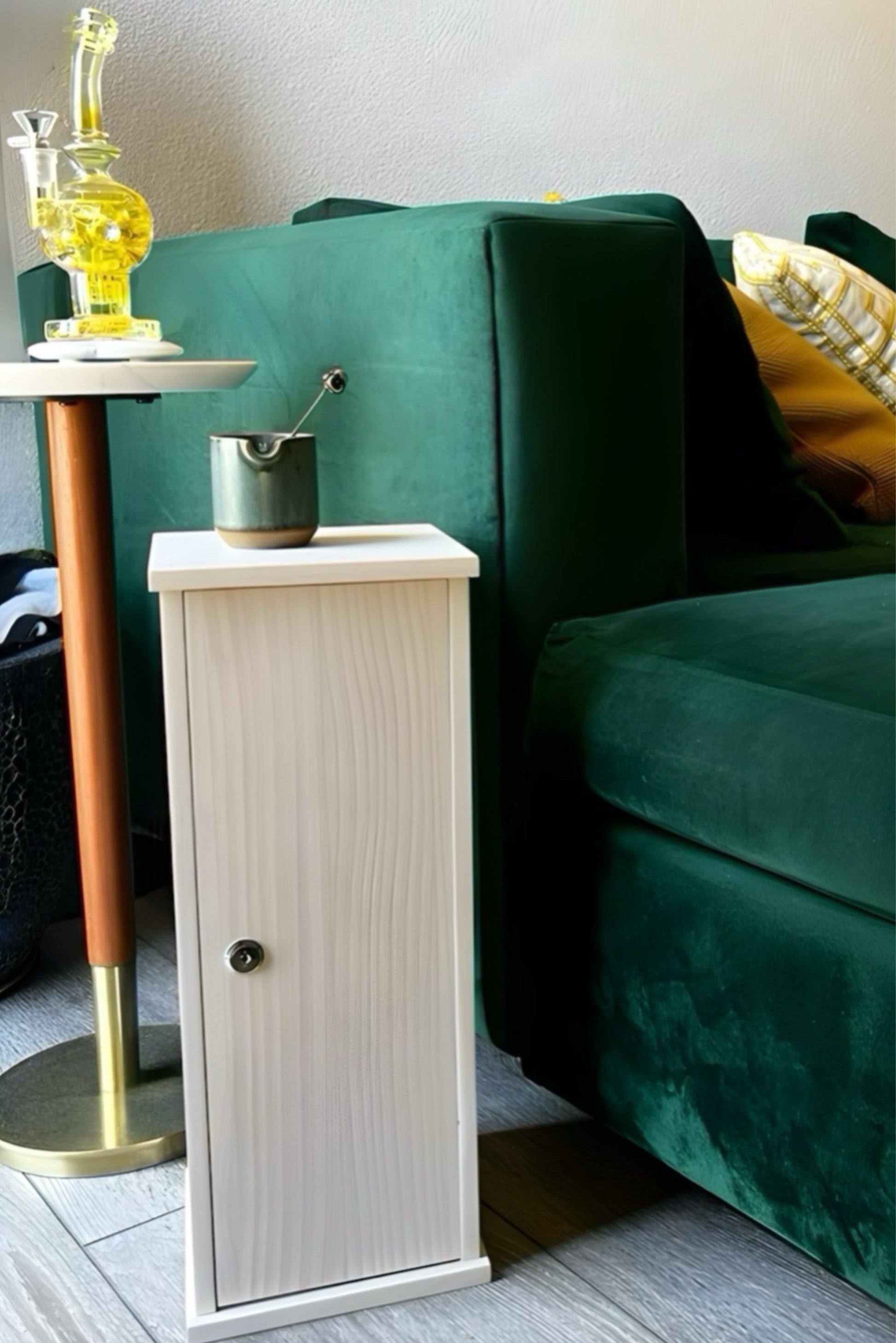 Small wooden side table with a green sofa and decorative items in the background